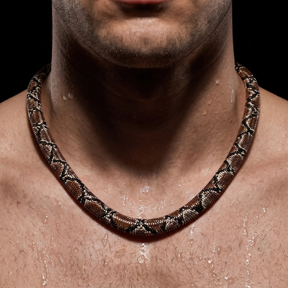 VENYRA serpent necklace worn by a man, close-up